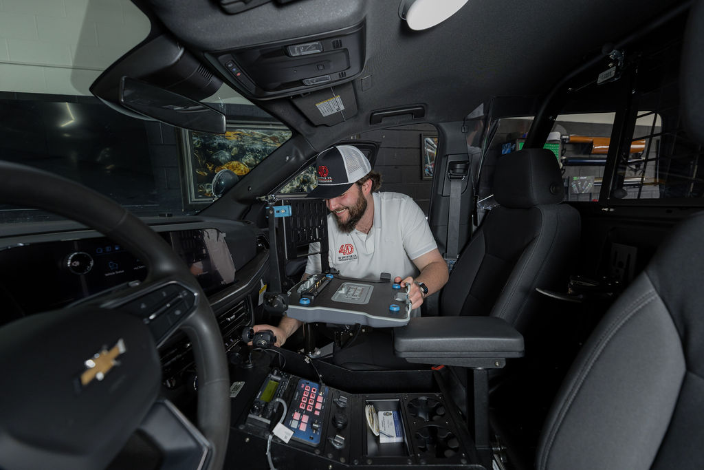 4D installer fitting a console in a patrol unit