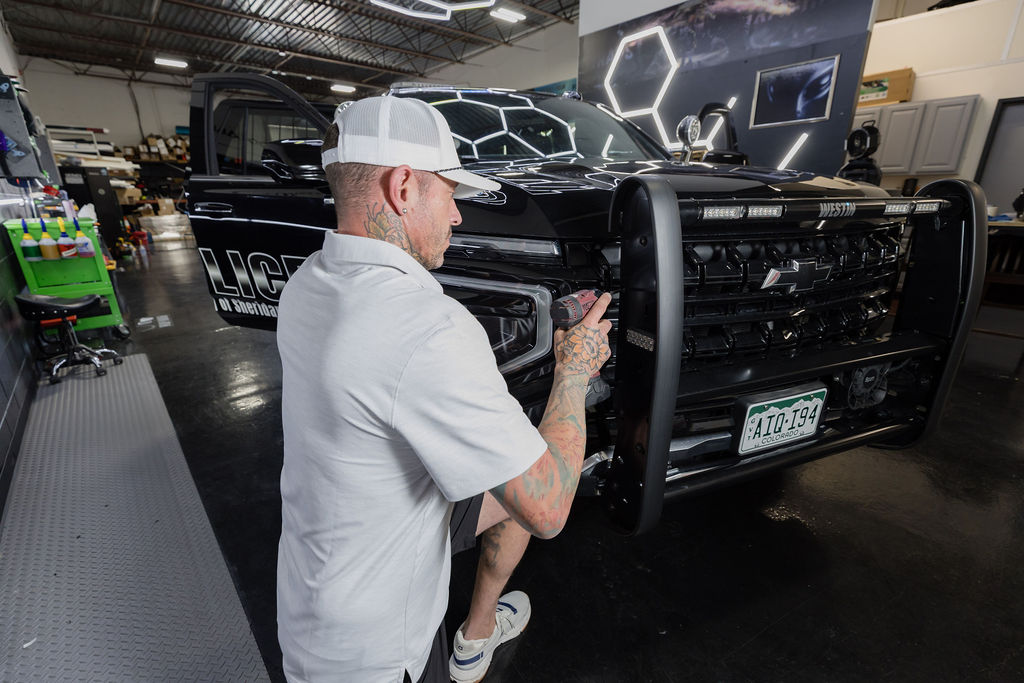 4D technician fitting a push bumper to a patrol unit